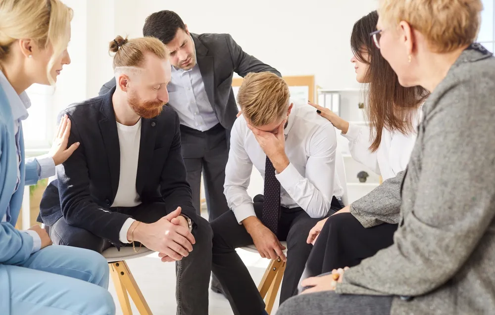 Adults sitting together in a supportive group discussion about ADHD and mental health