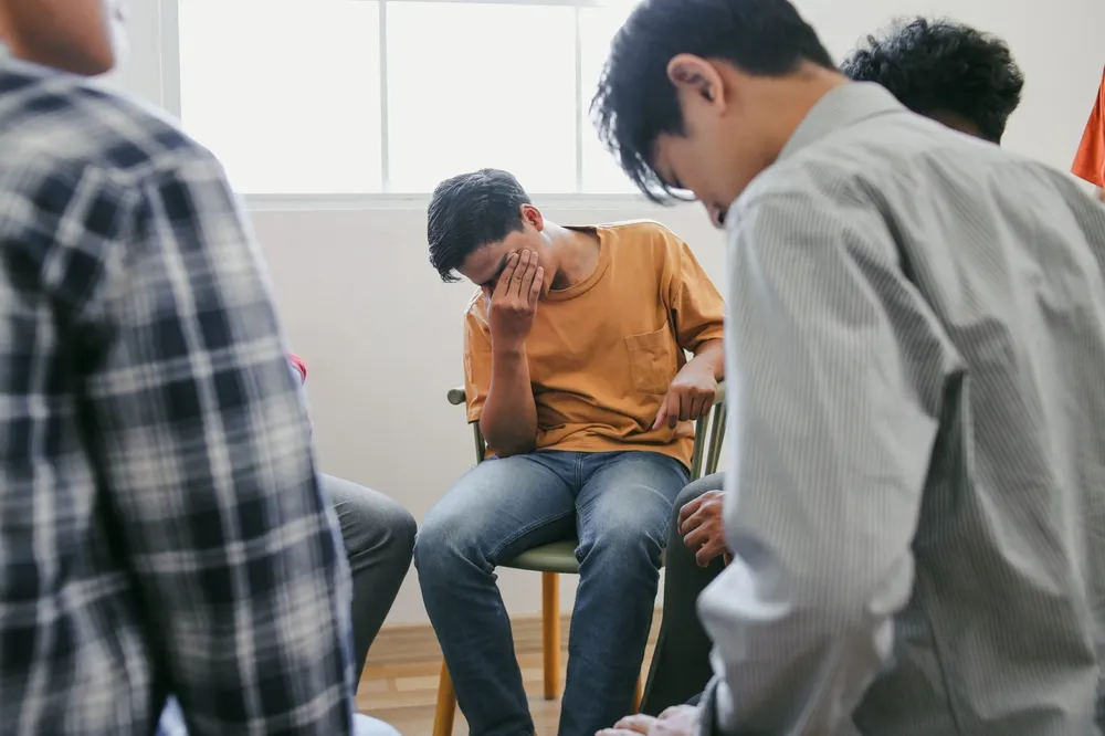 Small trauma support group sitting together in a calm and private setting