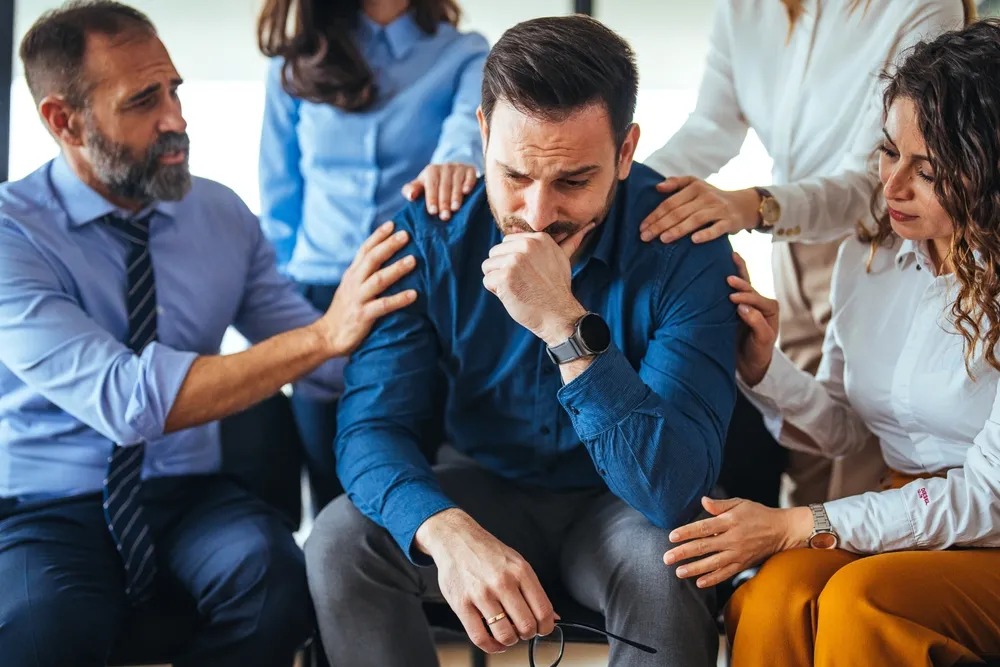 Small trauma support group sitting together in a calm and private setting