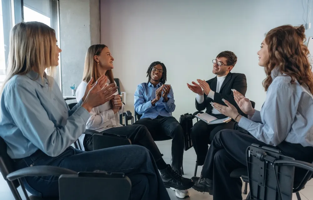 Small support group sitting together in a calm and private mental health setting