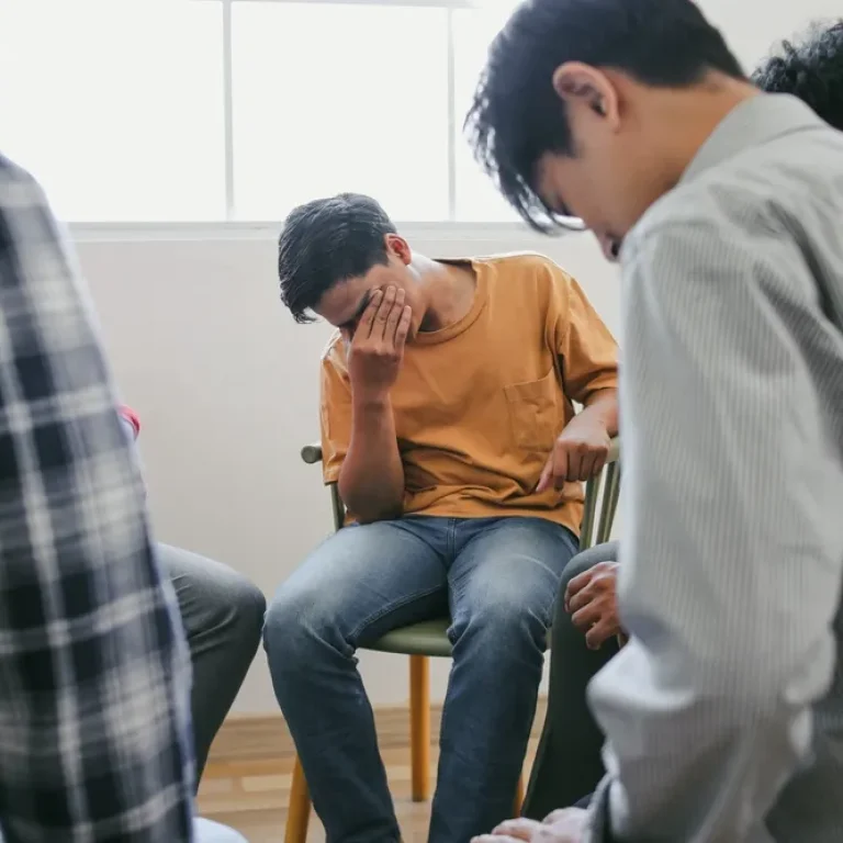 Small trauma support group sitting together in a calm and private setting