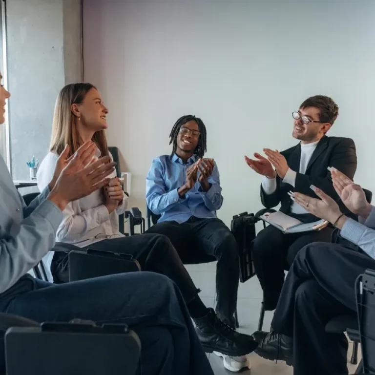Small support group sitting together in a calm and private mental health setting